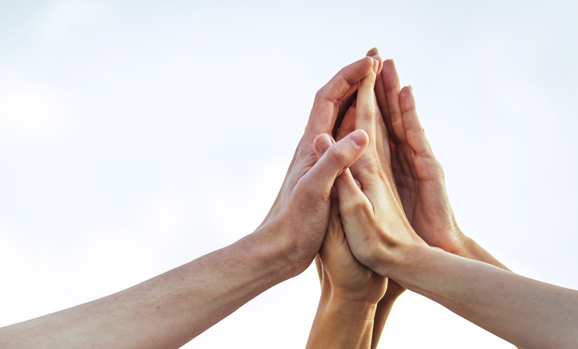 a photographic image of several people touching each other